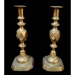 A PAIR OF VICTORIAN BRASS 'KING OF DIAMONDS' CANDLESTICKS Having a diamond lozenge design, retaining