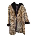 A VINTAGE FAUX FUR CHEETAH PATTERN COAT Brown collar and sleeve trims, knee length. (size 14, length