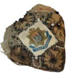 A WWI HEART FORM SILK SWEETHEART PIN CUSHION Decorated with East Sussex Regiment arms, silk threads,