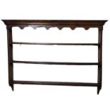 A LATE 18TH CENTURY OAK PLATE RACK Having a carved frieze and three open shelves. (approx 151cm x