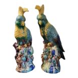 A PAIR OF 20TH CENTURY MAJOLICA TYPE MODELS, ORIENTAL PARROTS Brightly coloured and perched on a