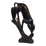A VINTAGE AFRICAN WOODEN CARVING, BLACK PANTHER Descending pose, on a rustic base. (approx 23cm)