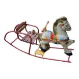 A VINTAGE CHILD'S NOVELTY MOBO ROCKING HORSE Based on metal and tin, the body painted in colours,
