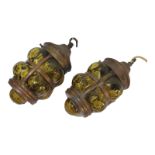 A PAIR OF ARTS & CRAFTS COPPER AND GREEN GLASS HANGING OVAL LANTERNS Frame with riveted copper strap