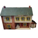 A VINTAGE SCRATCH BUILT WOODEN DOLLS HOUSE Having a pitched roof, side garage, removable back and