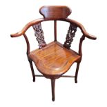 A MING DESIGN CHINESE HARDWOOD HOOP BACK CORNER CHAIR With pierced and carved rails and solid