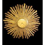GARRARD, AN ELECTRIC STAR DESIGN WALL CLOCK With metallic gold dial, Roman numerals, surrounded by