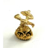 A 9CT GOLD AND BLACK ONYX EAGLE WATCH FOB/SEAL Having a bird form finial above a pierced crown and