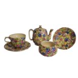ROYAL WINTON, AN ART DECO SWEET PEA PATTERN OF GRIMWADES SOLITAIRE TEA SERVICE FOR ONE Decorated