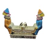 A VINTAGE FIBERGLASS FAIRGROUND DOUBLE CLOWN SWINGBOAT Two opposing clowns with two seats and