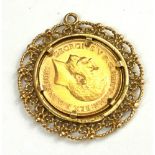 A KING GEORGE V 22CT GOLD HALF SOVEREIGN PENDANT, DATED 1922 With portrait bust and George and