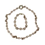 A 9CT GOLD ANCHOR LINK NECKLACE Together with a matching anchor link bracelet. (total weight 30.4g)