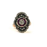 A VINTAGE STYLE 8CT ROSE GOLD (SILVER TOP) RING set with round diamonds and calibre cut rubies.