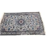 A PERSIAN RUG The central floral motif, repeating geometric floral design, on a blue and cream