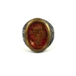 AN OTTOMAN STYLE SILVER SIGNET RING Having applied yellow metal calligraphy encased under glass