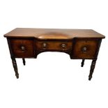 A GEORGE III (POSSIBLY IRISH) MAHOGANY BREAKFRONT SIDEBOARD Fitted with lion mask handles and