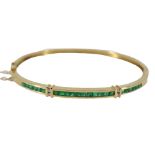 AN 18CT GOLD, EMERALD AND DIAMOND OVAL HINGED BRACELET. (approx weight 12.7g, 6.2cm x 5.5cm)