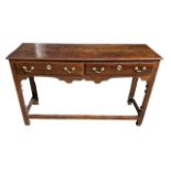 AN 18TH CENTURY OAK DRESSER BASE The plank top above two drawers raised on shaped square legs joined