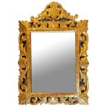 A 19TH CENTURY CONTINENTAL GILTWOOD MIRROR decorated with scrolling leaves. 83cm x 57cm