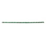 AN 18CT WHITE GOLD, OVAL CUT EMERALD AND DIAMOND LINE BRACELET. (approx emeralds 8.95ct, diamonds