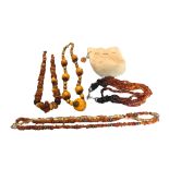 A LARGE BUTTERSCOTCH AMBER NECKLACE AND RING, TOGETHER WITH THREE OTHER BALTIC AMBER NECKLACES.