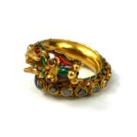 A YELLOW METAL DIAMOND, RUBY AND ENAMEL DRAGON BYPASS RING Dragon having ruby eyes with graduated