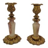 A PAIR OF 18TH CENTURY CONTINENTAL ROCOCO STYLE GILT METAL CANDLESTICKS Each having onyx column of