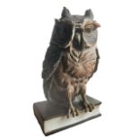 GUIDO CACCIAPUOTI, ITALIAN, 1892 - 1953, A LARGE PORCELAIN OWL PERCHED ON A BOOK Signed on spine. (h