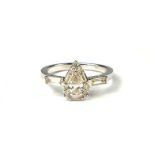 A PEAR SHAPED, BAGUETTE AND ROUND BRILLIANT CUT DIAMOND CLUSTER RING Set in a 9ct white gold. (