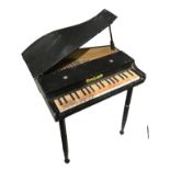 A JAPANESE NOVELTY BELL ‘GRAND PIANO’ Having a black lacquered finish.