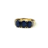 A 9CT GOLD THREE STONE SAPPHIRE AND DIAMOND RING. (approx total sapphire weight 2.45cr, gross weight