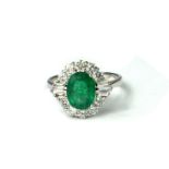 AN 18CT WHITE GOLD, EMERALD AND DIAMOND CLUSTER RING. (emerald 1.79ct, diamonds 0.78ct, TP 0.15ct/Rd