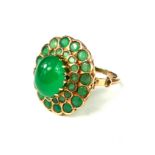 A LARGE 14CT GOLD CABOCHON EMERALD COCKTAIL RING Surrounded by a graduated emerald double halo