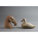 A POTTERY HORSE'S HEAD AND A DUCK, HAN DYNASTY (BC 206 - AD 220) The grey pottery applied with a red