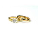 DE BEERS, AN 18CT GOLD AND 0.72 CARAT DIAMOND SOLITAIRE RING, TOGETHER WITH A 18CT GOLD AND