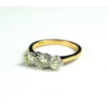 AN 18CT WHITE AND YELLOW GOLD DIAMOND TRILOGY RING with WGI certificate. (diamonds 1.26ct)