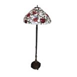 A TIFFANY STYLE BRONZE STANDARD LAMP With leaded glass shade figured with hearts. (h 130cm)