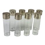 A SET OF EIGHT VINTAGE SILVER AND GLASS SHOT GLASSES Modelled as shotgun cartridges, marked to