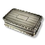 A GEORGIAN SILVER RECTANGULAR VINAIGRETTE With scrolled edge, engine turned decoration and gilt