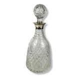 A MID 20TH CENTURY STERLING SILVER MOUNTED CRYSTAL CUT GLASS DECANTER AND STOPPER With diamond cut