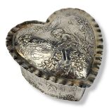 A 20TH CENTURY CONTINENTAL SILVER HEART FORM TRINKET BOX Embossed decoration of children at play,