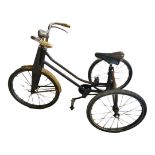 A 1950’S CAST IRON CHILD’S TRICYCLE Leather seat and iron frame with bell. (h 67cm x length 107cm)
