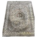 A LARGE SILK AND WOOL PERSIAN DESIGN RUG OF CARPET PROPORTIONS With traditional floral design on a