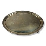A GEORGIAN CLASSICAL FORM OVAL SILVER SALVER With reeded border and engraved family crest to centre,