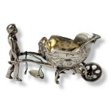 AN EARLY 20TH CENTURY CONTINENTAL SILVER FIGURAL SALT Classical form with a figure pushing a cart