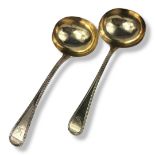 A PAIR OF VICTORIAN SILVER SAUCE LADLES Bead pattern with engraved emblem of a bird to finial,