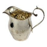 AN EARLY 20TH CENTURY SILVER CREAM JUG Classical form, with gadrooned border and scrolled handle,