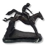 A BRONZE RACE HORSE AND JOCKEY SCULPTURE On a marble base depicting a hedge jumping. (h 33cm x