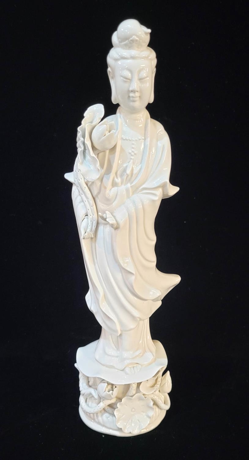 AN EARLY 20TH CENTURY CHINESE DEHUA BLANC DE CHINE FIGURE OF GUANYIN In long flowing lace robes,