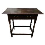 AN EARLY 18TH CENTURY OAK SIDE TABLE With single drawer, raised on square and turned legs. (88cm x